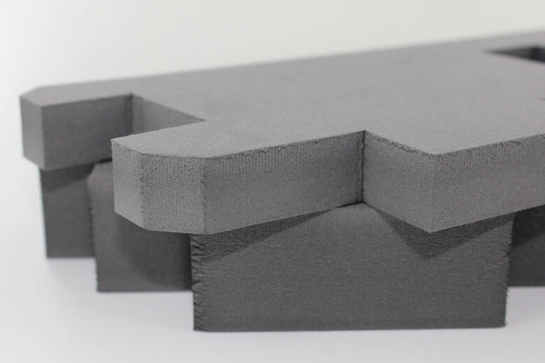 two pieces of thick grey polyethylene foam piled together that has been cut using a cnc cutting knife