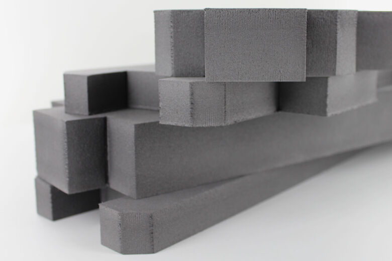 three pieces of thick grey polyethylene foam piled together that has been cut using a cnc cutting knife
